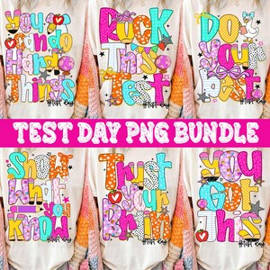 May include: A collection of six white t-shirts with colorful text designs. The shirts feature phrases like "You can do hard things" and "Rock this test." The text is in various fonts and colors, with additional graphics. The words "Test Day PNG Bundle" are in a pink banner.
