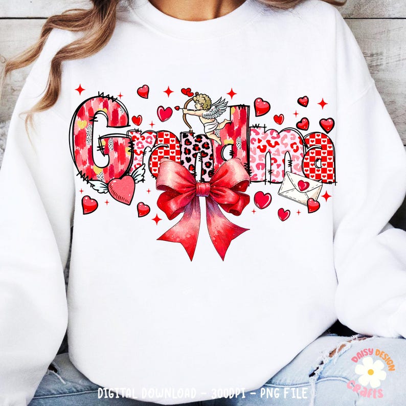 May include: White sweatshirt with the word "Grandma" in red, pink, and white patterned letters. The letters are decorated with hearts, a bow, and a cupid with an arrow.