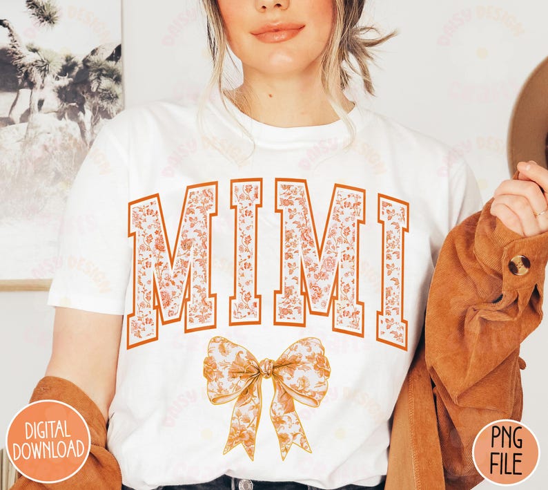 May include: White t-shirt with the word "MIMI" in orange and white floral print. A large orange and white floral bow is below the text.