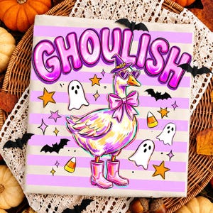 May include: A light-colored fabric featuring a horizontal striped pattern in light purple and white. The design displays a goose wearing a purple witch hat, heart-shaped sunglasses, and a pink bow, with pink boots. Text reads GHOULISH.