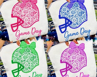 May include: Four white tote bags each display a football helmet design with floral patterns and a bow. The helmets are in pink, blue, green, and purple, with the words "Game Day" in matching colours. The text "DIGITAL DOWNLOAD- 5 DESIGNS- PNG FILES" is at the bottom.