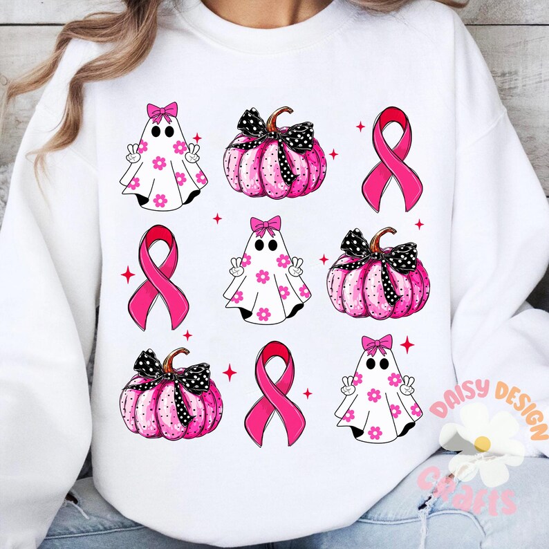 May include: White sweatshirt with a pink and black pattern of ghosts, pumpkins, and pink ribbons. The design is repeated throughout the sweatshirt.
