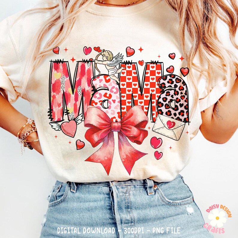 May include: A white t-shirt with a red, pink, and black graphic design that says "Mama" with a bow, hearts, and an angel with an arrow.