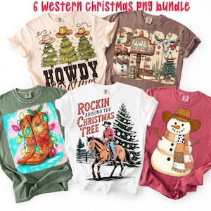 May include: A collection of six Western-themed Christmas t-shirts. Designs include cowboy hats on Christmas trees, a snowman wearing a cowboy hat and scarf, and a cowboy riding a horse. The shirts are in various colors, including white, beige, and maroon.