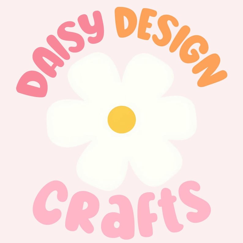 May include: A graphic logo featuring a white daisy flower with a yellow center. The word DAISY is written in pink above the flower, the word DESIGN is written in orange to the right, and the word CRAFTS is written in pink below the flower.