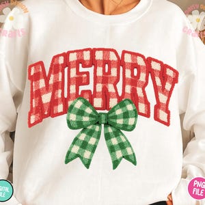 May include: White sweatshirt with the word "MERRY" in red and white plaid lettering. A green and white plaid bow is centered below the word. The sweatshirt is a digital file.