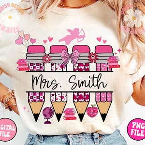 May include: A pink and white sublimation design for a t-shirt featuring a row of pencils with hearts and a stack of books. The text "Mrs. Smith" is written below the pencils.