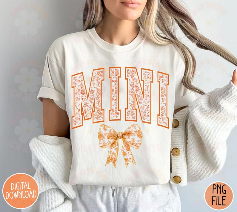 May include: White t-shirt with the word "MINI" in orange floral letters and a floral bow.