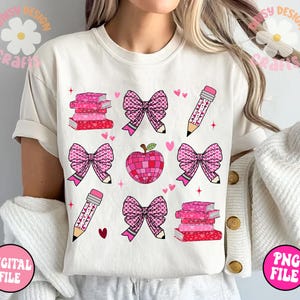 May include: A white t-shirt with a pink and red design featuring bows, pencils, books, and an apple. The design is centred on the shirt and includes the text "Digital File" and "PNG File".