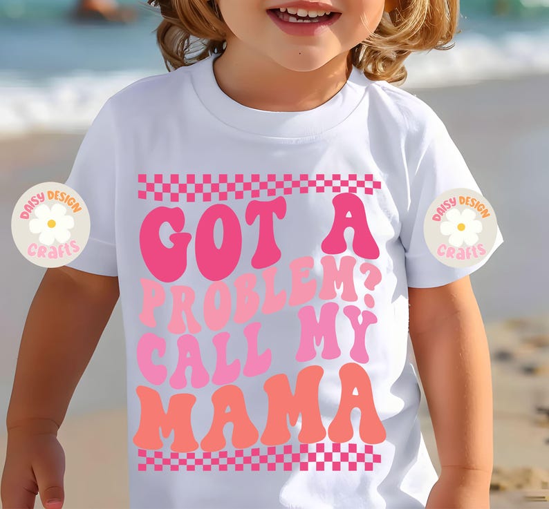 Op de afbeelding: Wit T-shirt met een roze en oranje afbeelding met de tekst "Got a problem? Call my mama" met een geruite rand.