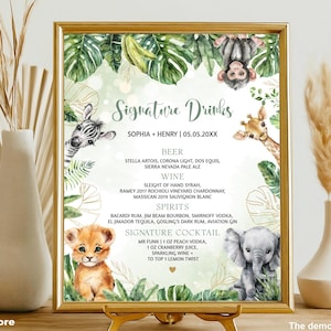 May include: A framed sign with a gold border, featuring a jungle theme with illustrations of a zebra, giraffe, lion cub, monkey, and elephant. The sign lists "Signature Drinks" with a cocktail recipe and drink options.