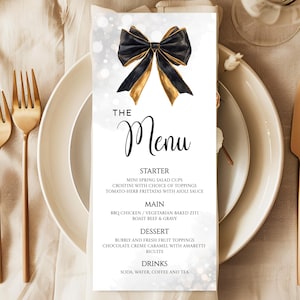 May include: A black and gold bow sits on a white background with a menu for a wedding or special event. The menu includes starter, main, dessert, and drinks options. The text reads "The Menu".