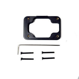 May include: A black plastic mounting bracket with four gold screws and a silver Allen wrench. There are four black screws included.