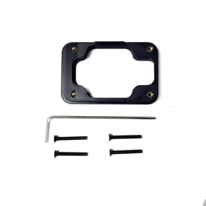 May include: A black plastic mounting bracket with four gold screws and a silver Allen wrench. There are four black screws included.