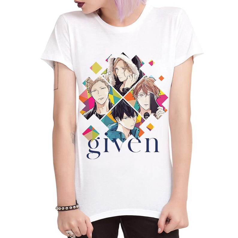 May include: White t-shirt with a colorful graphic design featuring four anime characters from the show "Given". The characters are arranged in a diamond shape with the word "given" printed below them.