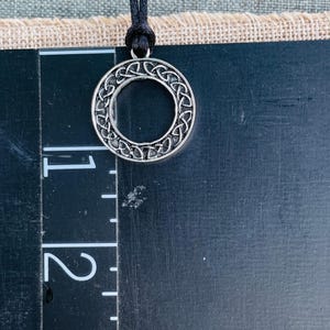 Round Celtic Knot pendant on a black nylon cord
