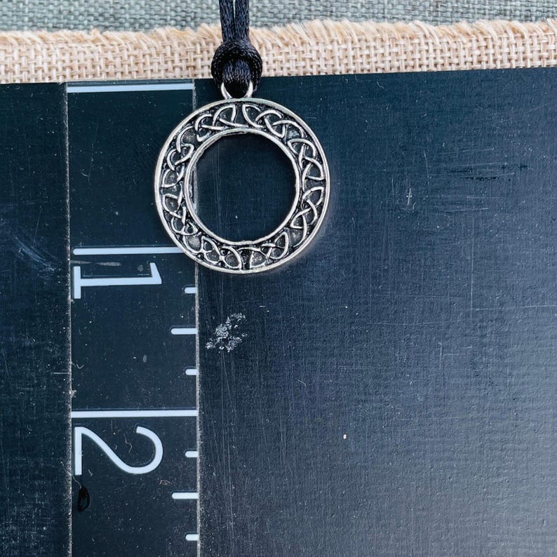 Round Celtic Knot pendant on a black nylon cord