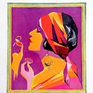 May include: A woman with dark hair is wearing a red, yellow, and black turban. She is holding a compact mirror in her right hand and applying makeup with her left hand. The background is a solid purple color.