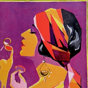 May include: A woman with a red, orange, and black turban is applying makeup with a compact mirror. She is wearing a gold earring and a purple and orange outfit.
