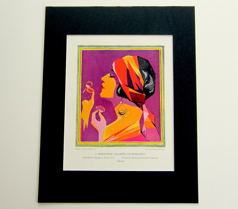 May include: A vintage magazine advertisement featuring a woman with a red and orange turban, wearing a pink and orange dress, and holding a compact mirror. The background is a vibrant purple.