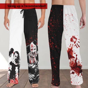 May include: Black and white pajama pants with a red splatter pattern. One leg features a graphic of a clown with a knife and the other leg features a bloody handprint.