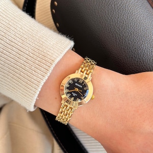 Reloj vintage redondo para mujer, color dorado, esfera negra, diseño vintage, regalo para ella, números romanos.