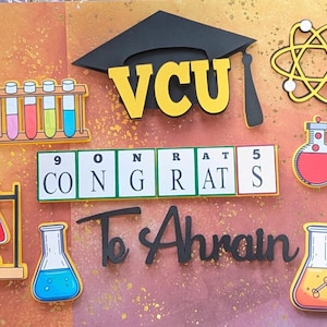 May include: A colorful graduation-themed design with a black mortarboard, the letters "VCU" in yellow, and various science-related illustrations. The design includes the text "CONGRATS To Ahrain" and images of beakers and a molecular structure.