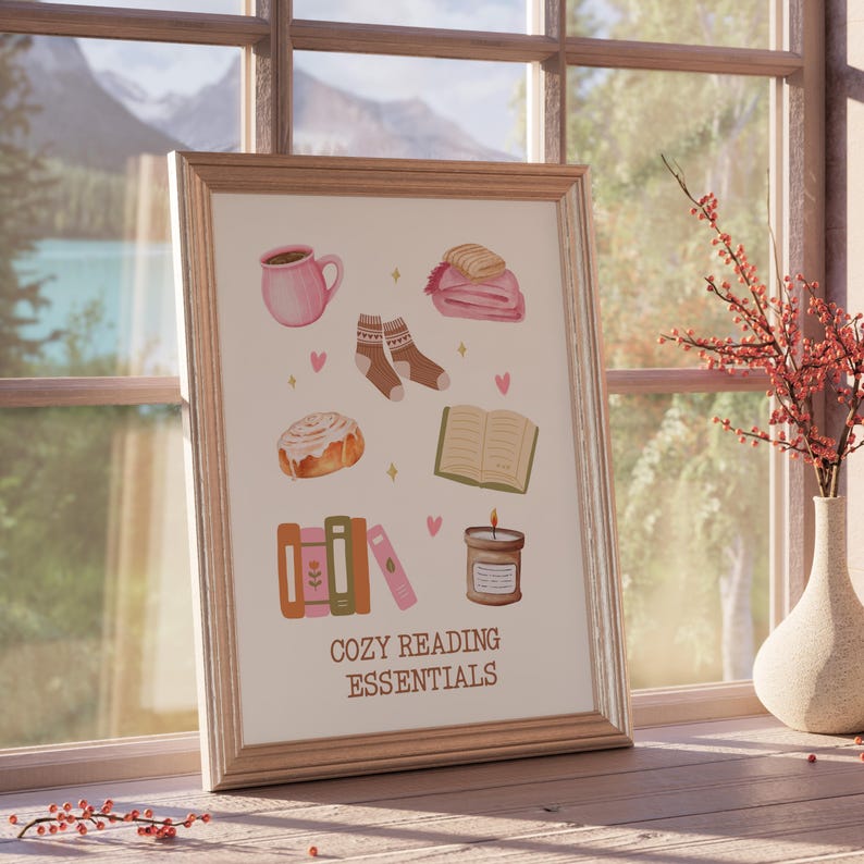 May include: A printable poster with illustrations of cozy reading essentials, including a book, a cup of coffee, a candle, a blanket, socks, and a cinnamon roll. The text "Cozy Reading Essentials" is at the bottom of the poster.