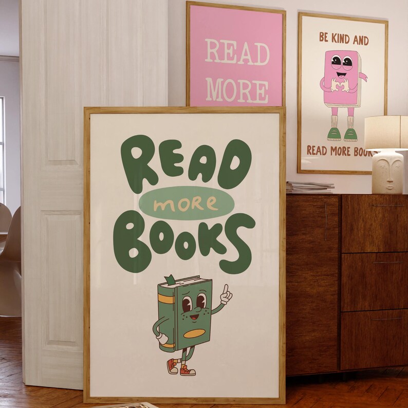 May include: A framed poster featuring a green cartoon book character holding a book and the text "Read More Books".