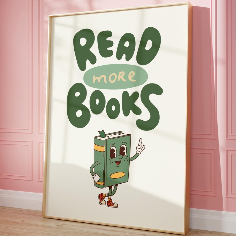 May include: A white poster with a gold frame features a green cartoon book character with a smiling face and the text "READ MORE BOOKS" in green letters.