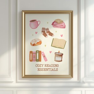 May include: A digital illustration of cozy reading essentials, including a cup of coffee, a book, a candle, a cinnamon roll, a blanket, and a pair of socks. The text "Cozy Reading Essentials" is at the bottom of the image.