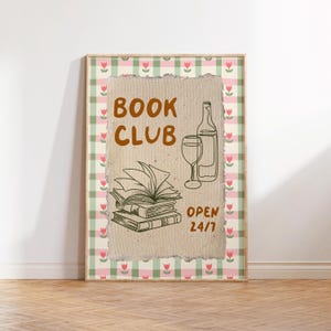May include: A brown and white poster with a gingham border and a torn edge. The poster says "Book Club" in brown text and features a drawing of a stack of books, a wine glass, and a bottle of wine. The poster also says "Open 24/7" in green text.