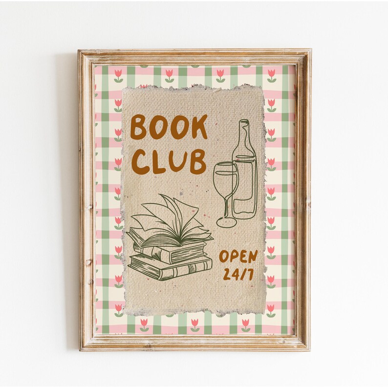 May include: A framed print with a brown paper background and a gingham border. The print features the text "BOOK CLUB" in brown lettering, a stack of books, a glass of wine, and a bottle of wine. The text "OPEN 24/7" is also included.