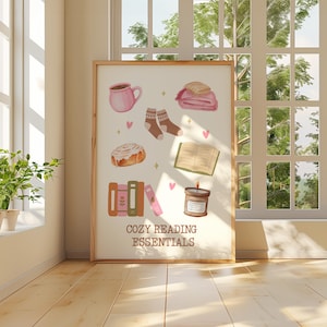 May include: A printable poster with a white background and illustrations of cozy reading essentials, including a cup of coffee, a book, a candle, a cinnamon roll, socks, and a blanket. The text "Cozy Reading Essentials" is at the bottom of the poster.