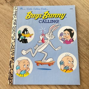 May include: A Little Golden Book cover featuring Bugs Bunny on a skateboard, holding a red phone. The book title is "Bugs Bunny Calling!" and features other cartoon characters like Daffy Duck, Porky Pig, and Tweety Bird.