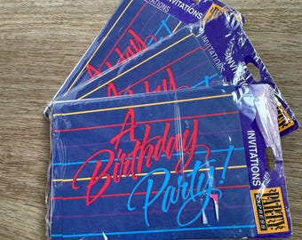 May include: A pack of 8 invitations for a birthday party. The invitations are blue with red, yellow, and blue stripes. The text on the invitations reads "A Birthday Party!" in a colorful, stylized font.