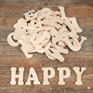 May include: A selection of unpainted wooden letters and heart shapes, with the word "HAPPY" spelt out at the bottom. The letters are light-coloured and rest on a wooden surface, ideal for crafting or DIY projects.