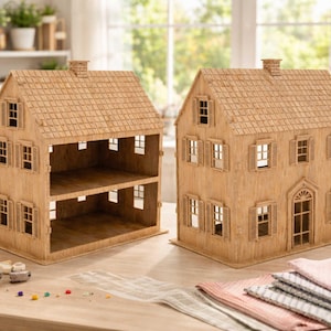 May include: Two wooden dollhouses with detailed facades, including windows, shutters, and shingle-style roofs. The dollhouses are light brown and sit on a wooden table. One dollhouse has two open stories, while the other has a detailed front door.