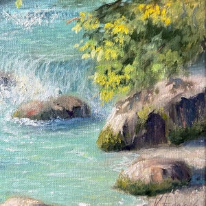May include: Oil painting depicting a river with turquoise water and rocks covered in moss. Green and yellow leaves overhang the water. The painting is signed in the bottom right corner.