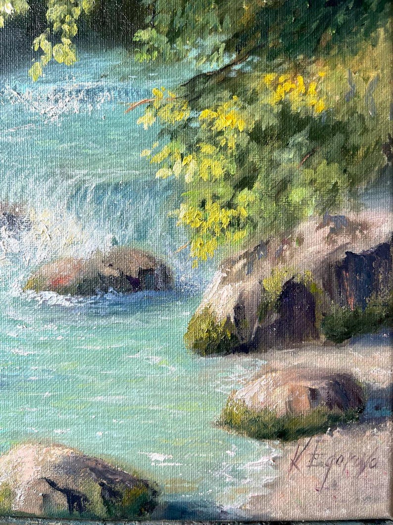 May include: Oil painting depicting a river with turquoise water and rocks covered in moss. Green and yellow leaves overhang the water. The painting is signed in the bottom right corner.