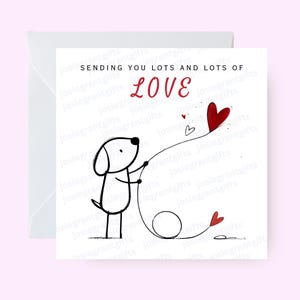 Può includere: Biglietto di auguri bianco con un'illustrazione in bianco e nero di un cane che tiene una corda con cuori rossi. Il testo recita "Sending you lots and lots of LOVE" in rosso.
