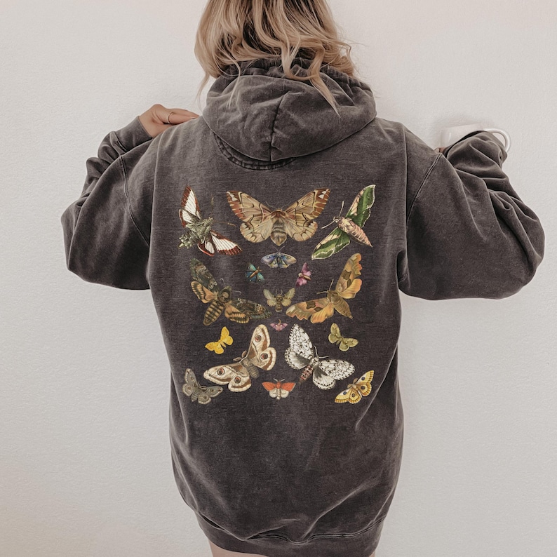 May include: A dark gray hooded sweatshirt with a vintage look featuring a print of various butterflies in shades of brown, yellow, green, and blue.