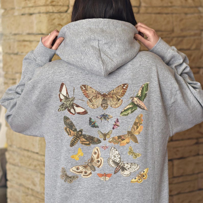 May include: A gray hooded sweatshirt with a print of various butterflies and moths in shades of brown, white, and black. The print covers the back of the sweatshirt.