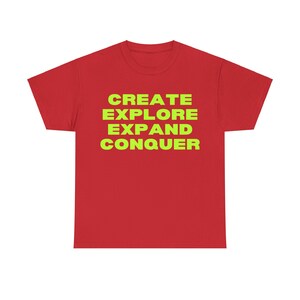 Puede incluir: Camiseta roja de manga corta con el texto "CREATE EXPLORE EXPAND CONQUER" en amarillo brillante.