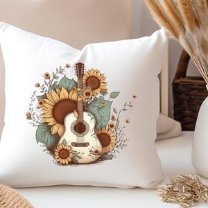 May include: White throw pillow with a graphic of a white acoustic guitar with brown strings surrounded by sunflowers and green leaves.
