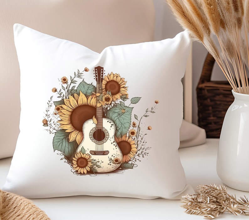 May include: White throw pillow with a graphic of a white acoustic guitar with brown strings surrounded by sunflowers and green leaves.