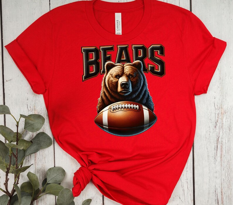 May include: Red t-shirt with a brown bear holding a football and the word "BEARS" in black letters.