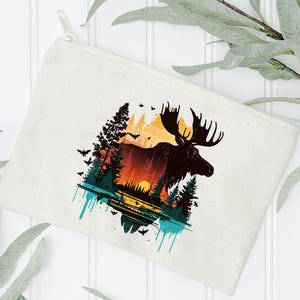 May include: A white canvas zippered pouch with a colorful graphic of a moose standing in a forest with a sunset in the background.