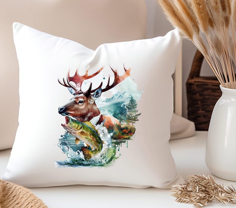 May include: White square cushion with a watercolour design of a deer with large antlers and a fish leaping from water. The deer is brown and orange, and the fish is green and yellow. The background includes mountains and trees.