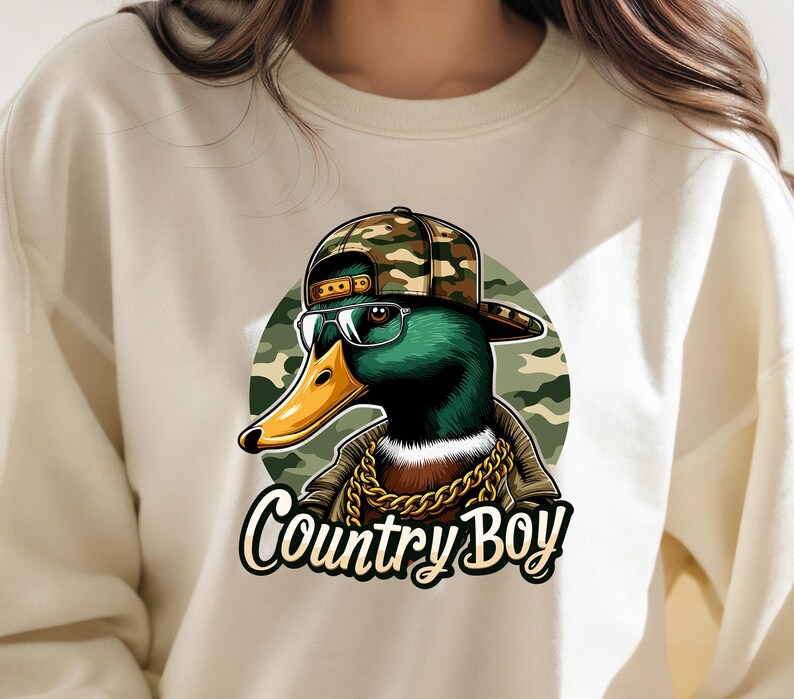 May include: A white sweatshirt featuring a graphic of a duck wearing a camouflage baseball cap, sunglasses, and a gold chain. The text "Country Boy" is printed below the duck.